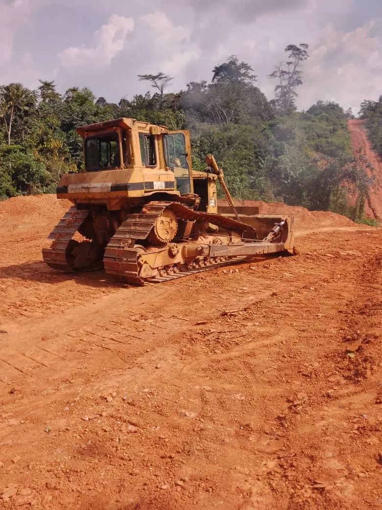 Earthmoving machinery grading soil